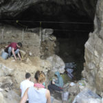 
              In this photo provided by Bence Viola in October 2022, researchers excavate a cave in the mountains of Siberia, Russia. In a study published Wednesday, Oct. 19, 2022, in the journal Nature, researchers were able to pull DNA out of tiny bone fragments found in two Russian caves, and used the genetic data to map out relationships between 13 different Neanderthals for clues to how they lived. (Bence Viola via AP)
            