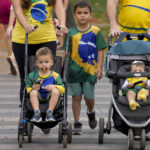 
              A family wearing Brazilian jerseys arrives at a polling station to vote during general elections, in Brasilia, Brazil, Sunday, Oct. 2, 2022. (AP Photo/Eraldo Peres)
            