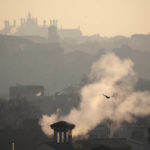 
              FILE - Smoke billows from chimneys of residential buildings in Rome, on Jan. 17, 2020. As she becomes Italy's first female premier, with the world is watching closely to see if she will emerge as a firebrand leader of a far-right party with neo-fascist roots or the more moderate right-wing politician who captured 26% of the vote, Giorgia Meloni will also be facing issues such as the energy crisis, civil rights, EU recover-fund, economy and internal coalition tensions with her allies. (AP Photo/Alessandra Tarantino, File)
            
