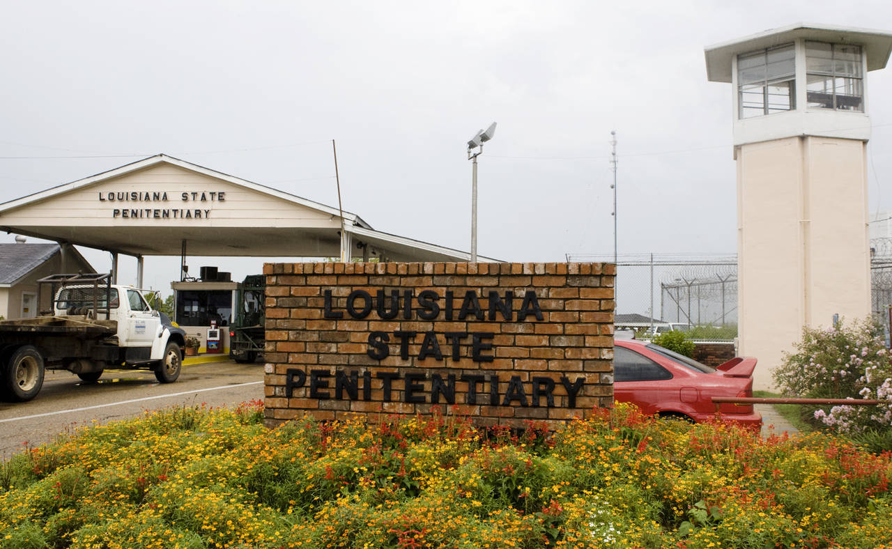 FILE - Vehicles enter at the main security gate at the Louisiana State Penitentiary — the Angola ...