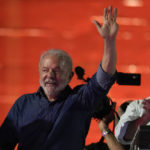 
              Former Brazilian President Luiz Inacio Lula waves to supporters gathered on Paulista Av. after he defeated incumbent Jair Bolsonaro in a presidential run-off election to become the country's next president, in Sao Paulo, Brazil, Sunday, Oct. 30, 2022. At right is running mate Geraldo Alckmin. (AP Photo/Andre Penner)
            
