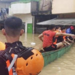 
              In this handout photo provided by the Philippine Coast Guard, rescuers evacuate residents at a flooded village in Tuguegarao city, Cagayan province, northern Philippines on Sunday Oct. 30, 2022. Victims of a huge mudslide set off by a storm in a coastal Philippine village that had once been devastated by a killer tsunami mistakenly thought a tidal wave was coming and ran to higher ground toward a mountain and were buried alive, an official said Sunday. (Philippine Coast Guard via AP)
            