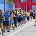 
              Voters line up during general elections in Brasilia, Brazil, Sunday, Oct. 2, 2022. (AP Photo/Eraldo Peres)
            