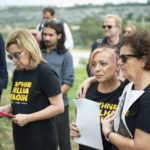
              People stand during a silent gathering to remember Daphne Caruana Galizia, at the same place where she was killed in Bidnija fields, Malta, Sunday, Oct. 16, 2022. Malta on Sunday marked the fifth anniversary of the car bomb slaying of investigative journalist Daphne Caruana Galizia, just two days after two key suspects reversed course and pleaded guilty to the murder on the first day of their trial. (AP Photo/Rene' Rossignaud)
            