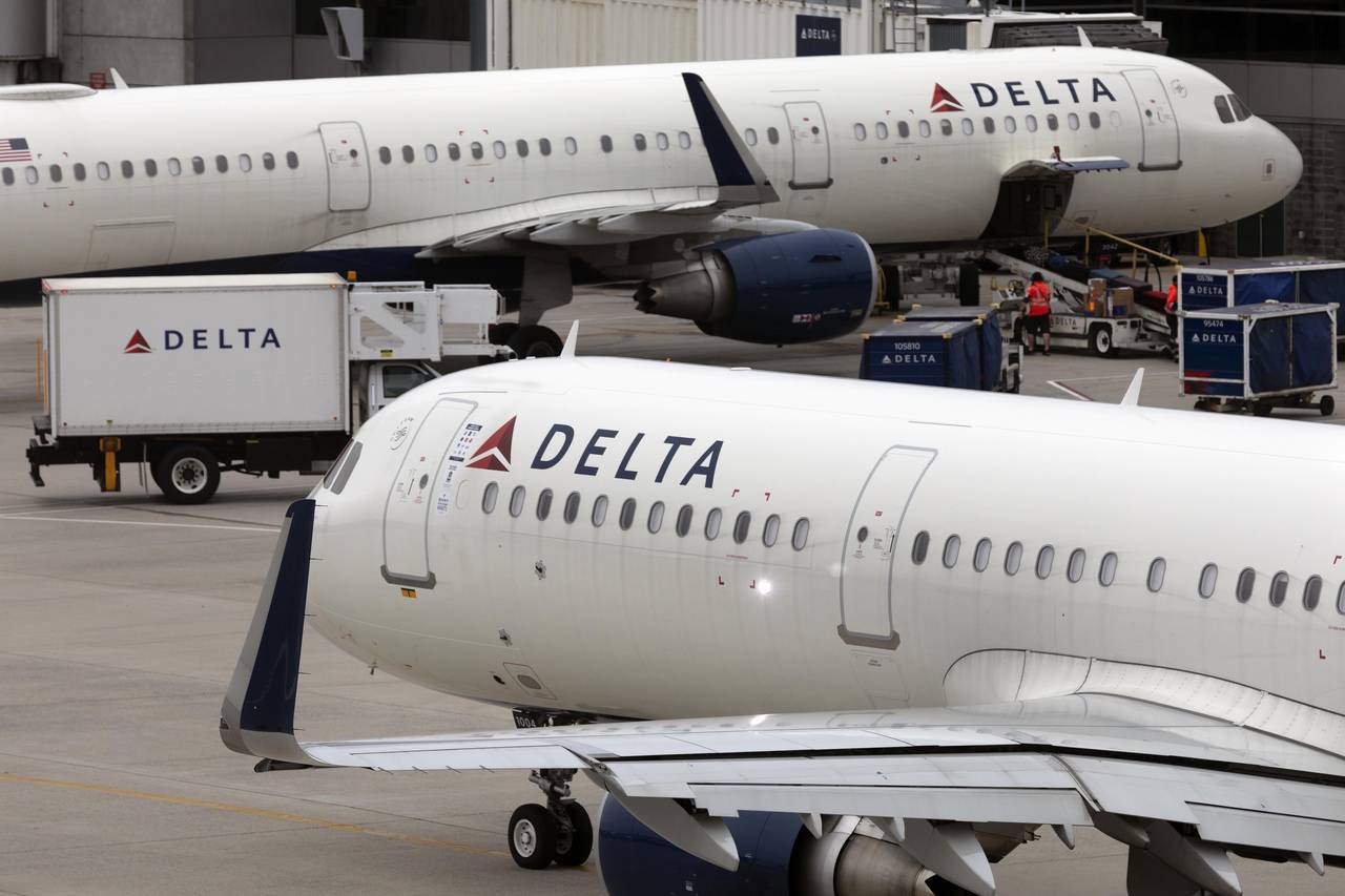 FILE - A Delta Air Lines plane leaves the gate on July 12, 2021, at Logan International Airport in ...