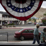 
              FILE - People walk along the main drag in the county seat of Nye County on July 18, 2022, in Tonopah, Nev. Nevada voters will consider a ballot question on Nov. 8, 2022, that would enshrine in the state constitution a ban on discrimination based on race, color, creed, sex, sexual orientation, gender identity or express, age, disability, ancestry or national origin. Nevadans will also weigh in on ranked-choice voting and the state's minimum wage. (AP Photo/John Locher, File)
            