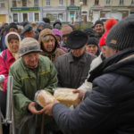 
              Local residents stand in line waiting for free bread from volunteers in Bakhmut, the site of the heaviest battle against the Russian troops in the Donetsk region, Ukraine, Friday, Oct. 28, 2022. (AP Photo/Efrem Lukatsky)
            