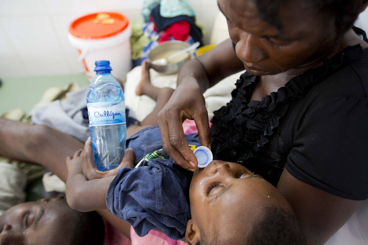 FILE - A boy diagnosed with cholera receives treatment at a cholera center in Anse D'Hainault, Hait...