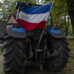 
              The Dutch flag flies upside down from a tractor during a small protest outside parliament, where Johan Remkes, an independent mediator, delivered his report into the Dutch government's plans to drastically reduce emissions of nitrogen pollutants by the country's agricultural sector during a press conference in The Hague, Netherlands, Wednesday, Oct. 5, 2022. The plans have sparked nationwide protests by angry farmers who fear for their livelihoods. (AP Photo/Peter Dejong)
            