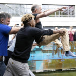 
              Swedish scientist Svante Paabo is thrown into a pool outside the Max Planck Institute for Evolutionary Anthropology in Leipzig, Germany, Monday, Oct. 3, 2022. Swedish scientist Svante Paabo was awarded the 2022 Nobel Prize in Physiology or Medicine for his discoveries on human evolution. (Hendrik Schmidt/dpa via AP)
            