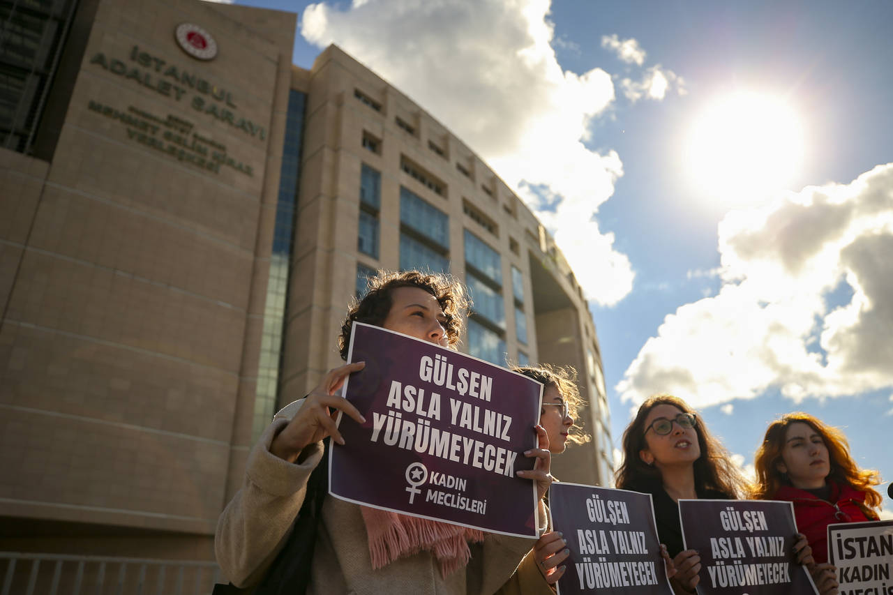 A group of women hold placards that read "Gulsen will never walk alone" in front of Istanbul Courth...