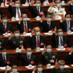 
              Delegates attend the closing ceremony of the 20th National Congress of China's ruling Communist Party at the Great Hall of the People in Beijing, Saturday, Oct. 22, 2022. (AP Photo/Ng Han Guan)
            