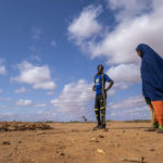 
              Fartum Issack, right, and her husband, Adan, stand by the grave of their 1-year-old daughter at a displacement camp on the outskirts of Dollow, Somalia, on Monday, Sept. 19, 2022. The graveyard opened in April, and there's easily room for hundreds more graves. (AP Photo/Jerome Delay)
            