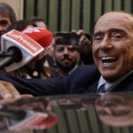 
              Silvio Berlusconi is mobbed by press as he leaves a reunion to decide the group leaders of at the Lower Chamber, in Rome, Tuesday, Oct.18, 2022. ( Cecilia Fabiano/LaPresse via AP)
            