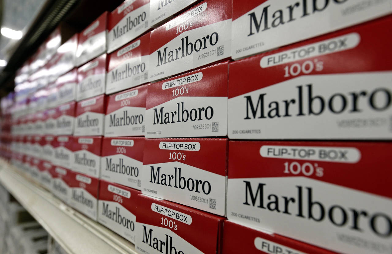 FILE- This June 14, 2018, file photo shows cartons of Marlboro cigarettes on the shelves at JR outl...