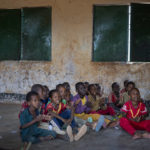 
              Children attend a class in a school in Dollow, Somalia, on Monday, Sept. 19, 2022. At midday, dozens of hungry children from the camps try to slip into a local primary school where the World Food Program offers a rare lunch program for students. (AP Photo/Jerome Delay)
            