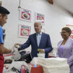 
              President Joe Biden pays for a takeout order at Tacos 1986, a Mexican restaurant, in Los Angeles, Thursday, Oct. 13, 2022. With the president are Rep. Karen Bass, D, Calif., and Los Angeles County supervisor Hilda Solis. (AP Photo/Carolyn Kaster)
            