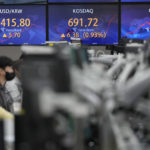 
              Currency traders watch their computer monitors near the screens showing the foreign exchange rate between U.S. dollar and South Korean won, left, and the Korean Securities Dealers Automated Quotations (KOSDAQ), center, at a foreign exchange dealing room in Seoul, South Korea, Thursday, Oct. 6, 2022. Asian stocks were mixed Thursday after strong U.S. hiring dampened hopes the Federal Reserve might ease off plans for interest rate hikes and the OPEC group of oil exporters agreed to output cuts to shore up prices. (AP Photo/Lee Jin-man)
            
