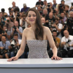 
              FILE - Marion Cotillard poses for photographers at the photo call for the film 'Brother and Sister' at the 75th international film festival, Cannes, southern France, Saturday, May 21, 2022. Oscar-winning actresses Marion Cotillard and Juliette Binoche, as well as other French stars of screen and music, filmed themselves chopping off locks of their hair in a video posted Wednesday Oct.5, 2022 in support of protesters in Iran. (AP Photo/Petros Giannakouris, File)
            