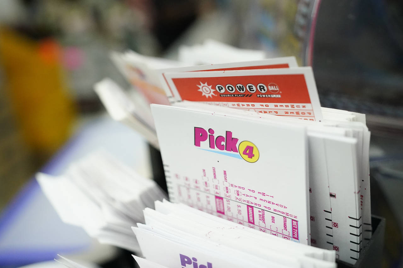 FILE - Lottery play stubs, including one for the Powerball, are seen on display at a liquor store, ...