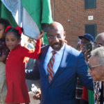 
              FILE - Sen. Raphael Warnock stands with his children, Caleb and Chloe, and his mother, Verlene Warnock, before unveiling a sign designating a street as Honorary Raphael Warnock Way in the Senator's hometown of Savannah, Ga., Oct. 6, 2022. Warnock, a freshman Democrat, is up for reelection in November in a pivotal race against Republican and former football star Herschel Walker. (AP Photo/Russ Bynum, File)
            