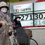 
              People push their bicycle in front of an electronic stock board showing Japan's Nikkei 225 index at a securities firm Friday, Oct. 28, 2022, in Tokyo. Shares were mostly lower in Asia on Friday after a mixed session on Wall Street, where tech sector losses offset gains in other parts of the market. (AP Photo/Eugene Hoshiko)
            