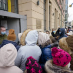 
              FILE --People from the Ukraine most of them refugees fleeing the war, wait in front of the consular department of the Ukrainian embassy in Berlin, Germany, Friday, April 1, 2022. German government pledged Tuesday to provide more support to cities and towns struggling to house more than 1.1 million refugees who have arrived in the country this year mostly from war-torn Ukraine but also other countries such as Syria and Afghanistan.(AP Photo/Markus Schreiber,file)
            