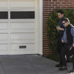 
              Paul Pelosi Jr., son of U.S. Speaker of the House Nancy Pelosi and Paul Pelosi, background, walks with security personnel outside his parent's home the day after an intruder violently attacked Paul Pelosi at the home in San Francisco, Saturday, Oct. 29, 2022. (Stephen Lam/San Francisco Chronicle via AP)
            