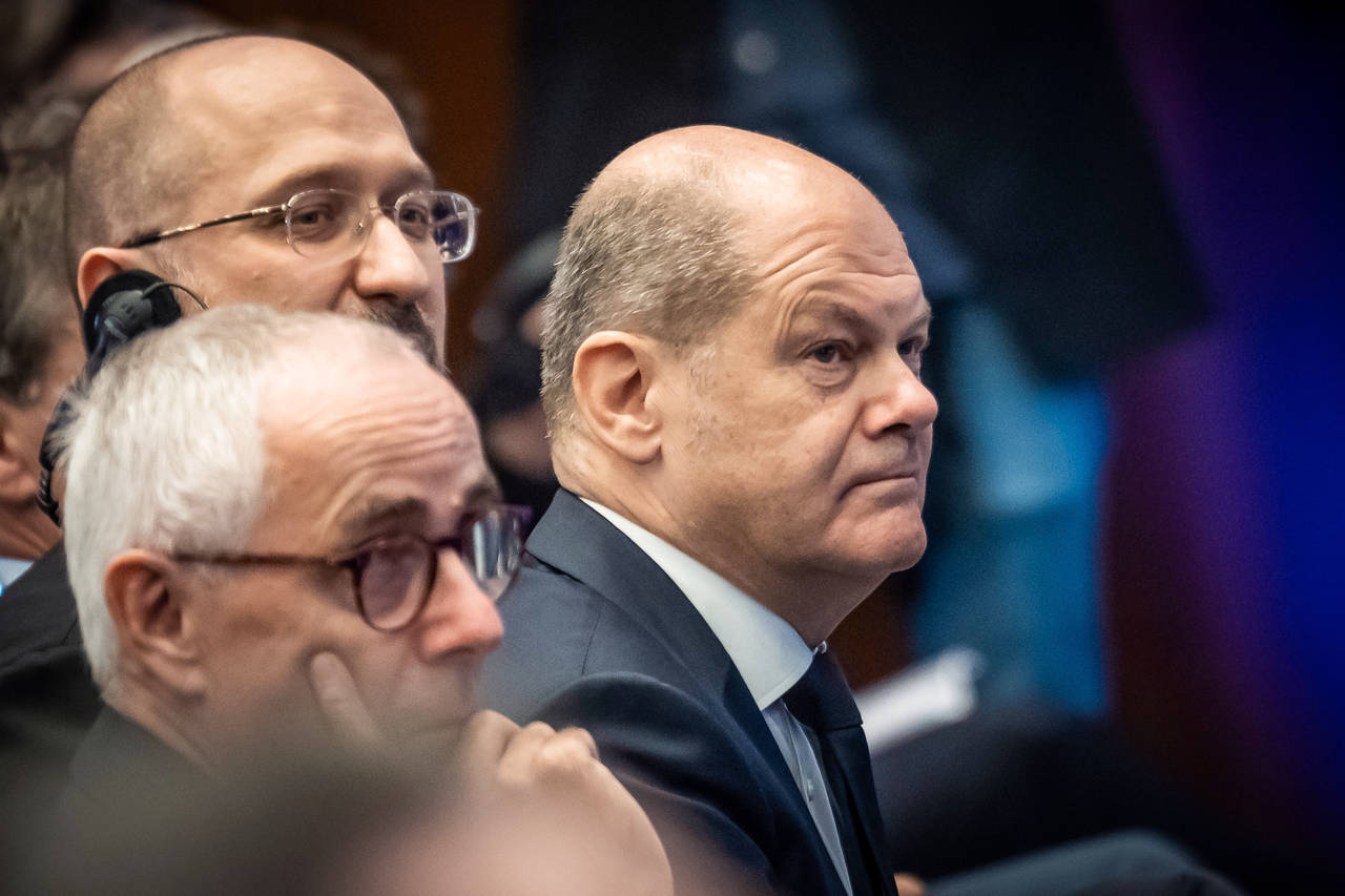 German Chancellor Olaf Scholz, sits next to Denis Shmyhal (M), Prime Minister of Ukraine, and Peter...