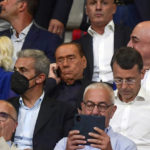
              FILE - Former Italian Prime Minister Silvio Berlusconi, middle center, right, owner of Monza, is flanked by Adriano Galliani, partially seen at right, as he talks on his phone during a Serie A soccer match between Monza and Torino at the U-Power Stadium in Monza, Italy, Saturday, Aug. 13, 2022. Much of the attention will be focused off the field when Monza takes on defending champion AC Milan on Saturday, Oct. 22, 2022. There will be familiar faces in the directors’ box at San Siro as Silvio Berlusconi and Adriano Galliani return to the club they led to 29 trophies in 31 years. (Claudio Grassi/LaPresse via AP, File)
            