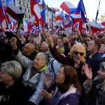 
              People cheer as several thousands of protesters from the far right and far left gathered to rally against the country's pro-Western Czech government at the Vencesla's Square in Prague, Czech Republic, Friday, Oct. 28, 2022. (AP Photo/Petr David Josek)
            