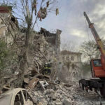 
              In this photo provided by the Ukrainian Emergency Service, rescuers work at the scene of a building damaged by shelling in Zaporizhzhia, Ukraine, Thursday, Oct. 6, 2022. (Ukrainian Emergency Service via AP)
            