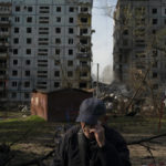 
              Mucola Markovich, 76, wipes a tear as he stands next to a residential building that was heavily damaged after a Russian attack at a residential area in Zaporizhzhia, Ukraine, Sunday, Oct. 9, 2022. (AP Photo/Leo Correa)
            