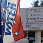 
              Ballot drop box outside of the Mason County auditors office is seen behind a voter registration banner, Thursday, Oct. 13, 2022, in Shelton, Wash. Washington is an all-mail voting state. (AP Photo/John Froschauer)
            