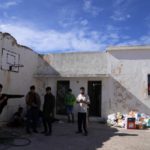 
              Migrants, most of them from Afghanistan, gather at an old school used as a temporary shelter on the island of Kythira, southern Greece, Thursday, Oct. 6, 2022. Bodies floated amid splintered wreckage in the wind-tossed waters off a Greek island Thursday as the death toll from the separate sinkings of two migrant boats rose to 22, with many still missing. (AP Photo/Thanassis Stavrakis)
            