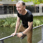 
              Swedish scientist Svante Paabo climbs out of a pool after his colleagues threw him into it, outside the Max Planck Institute for Evolutionary Anthropology in Leipzig, Germany, Monday, Oct. 3, 2022. Swedish scientist Svante Paabo was awarded the 2022 Nobel Prize in Physiology or Medicine for his discoveries on human evolution. (Hendrik Schmidt/dpa via AP)
            