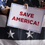 
              Republican supporter holds a Save America sign at a rally for former President Donald Trump at the Minden Tahoe Airport in Minden, Nev., Saturday, Oct. 8, 2022. (AP Photo/José Luis Villegas, Pool)
            