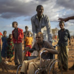 
              Displaced people who have arrived at a camp wait for plot allocation on the outskirts of Dollow, Somalia, on Monday, Sept. 19, 2022.  Somalia is in the midst of the worst drought anyone there can remember. A rare famine declaration could be made within weeks. Climate change and fallout from the war in Ukraine are in part to blame. (AP Photo/Jerome Delay)
            