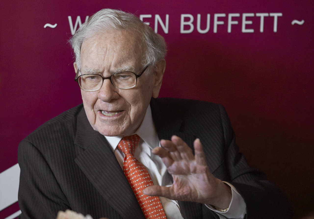 FILE - Warren Buffett, Chairman and CEO of Berkshire Hathaway, speaks during a game of bridge follo...