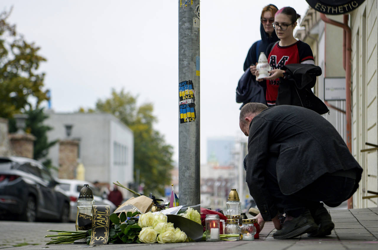 People lay flowers and light candles at the scene of Wednesday's attack on Zamocka Street in Bratis...