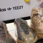 
              A sign advertises Yeezy shoes made by Adidas at Kickclusive, a sneaker resale store, in Paramus, N.J., Tuesday, Oct. 25, 2022. Adidas has ended its partnership with the rapper formerly known as Kanye West over his offensive and antisemitic remarks, the latest company to cut ties with Ye and a decision that the German sportswear company said would hit its bottom line. (AP Photo/Seth Wenig)
            