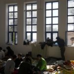 
              Migrants, most of them from Afghanistan, rest at an old school used as a temporary shelter on the island of Kythira, southern Greece, Friday, Oct. 7, 2022. Strong winds were hampering rescue efforts at two Greek islands Friday for at least 10 migrants believed to be missing after shipwrecks left more than 20 people dead, officials said. (AP Photo/Thanassis Stavrakis)
            