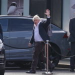 
              Former Prime Minister Boris Johnson arrives at Gatwick Airport in London, after travelling on a flight from the Caribbean, following the resignation of Liz Truss as Prime Minister, Saturday Oct. 22, 2022. (Gareth Fuller/PA via AP)
            