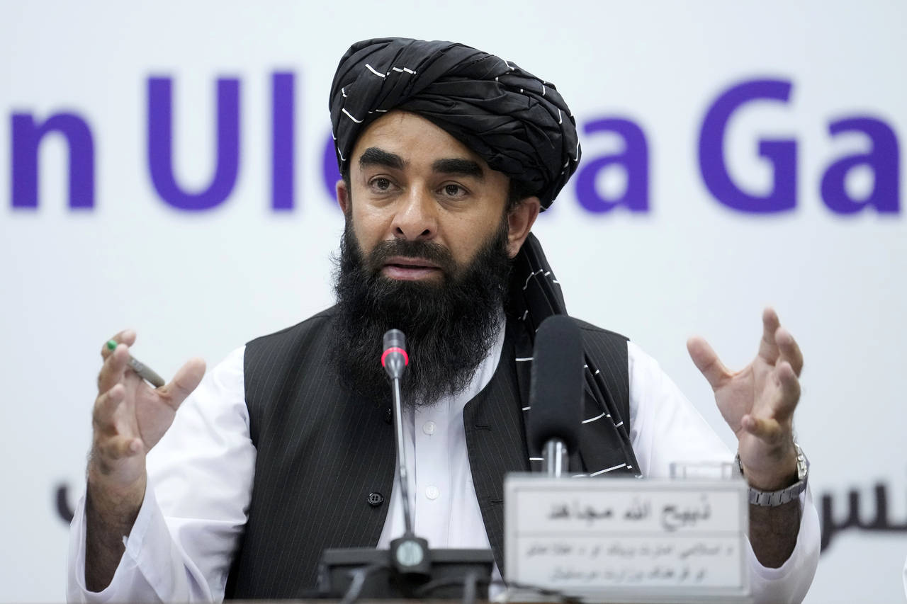 FILE - Zabiullah Mujahid, the spokesman for the Taliban government, speaks during a press conferenc...