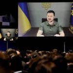 
              Ukrainian President Volodymyr Zelenskyy is seen on a screen as he delivers his speech during the International Expert Conference on the Recovery, Reconstruction and Modernisation of Ukraine, in Berlin, Germany, Tuesday, Oct. 25, 2022. German and European Union leaders gathered experts on Tuesday to start work on what they describe as a “new Marshall plan” for the rebuilding of Ukraine. (AP Photo/Markus Schreiber)
            