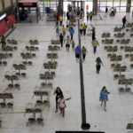 
              Voters arrive to a polling station during general elections in Brasilia, Brazil, Sunday, Oct. 2, 2022. (AP Photo/Eraldo Peres)
            