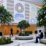 
              Attendees gather inside an atrium at the 2022 Annual Meetings of the International Monetary Fund and the World Bank Group, Monday, Oct. 10, 2022, in Washington. (AP Photo/Patrick Semansky)
            