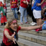 
              A follower of former Brazilian President Luiz Inacio "Lula" da Silva, who is again running for president, celebrates partial results after general election polls closed in Rio de Janeiro, Brazil, Sunday, Oct. 2, 2022. (AP Photo/Silvia Izquierdo)
            