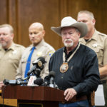 
              Merced County Sheriff Vern Warnke, foreground, speaks at a news conference about the kidnapping of 8-month-old Aroohi Dheri, her mother Jasleen Kaur, her father Jasdeep Singh, and her uncle Amandeep Singh, in Merced, Calif., on Wednesday, Oct. 5, 2022. Relatives of a family kidnapped at gunpoint from their trucking business in central California pleaded for help Wednesday in the search for an 8-month-old girl, her mother, father and uncle, who authorities say were taken by a convicted robber who tried to kill himself a day after the kidnappings. (Andrew Kuhn/The Merced Sun-Star via AP)
            