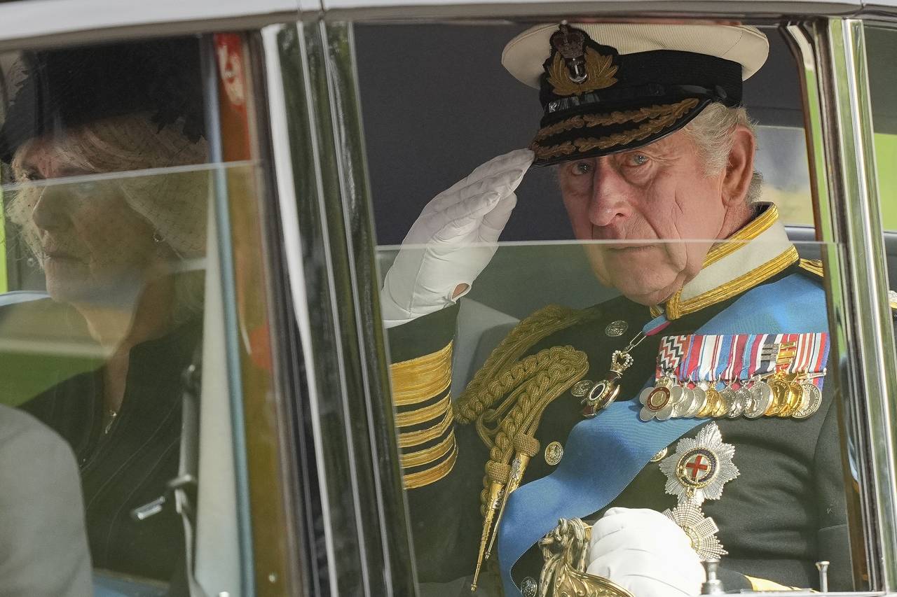 FILE - King Charles III salutes as he leaves Westminster Abbey following the state funeral service ...